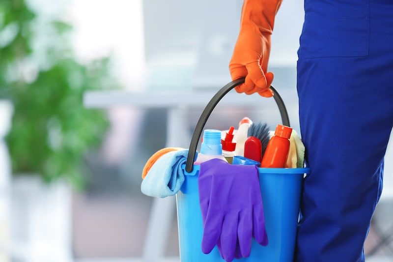 A bucket full of cleaning tools