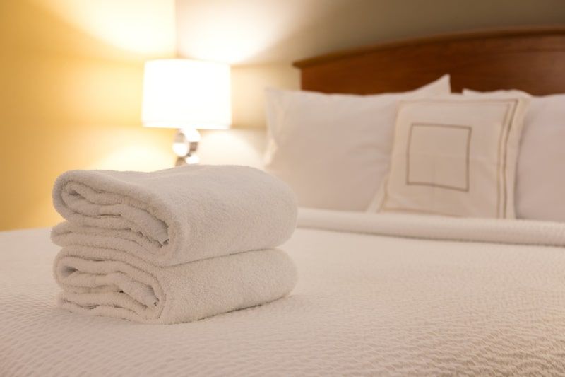 Towels folded up and placed on a bed