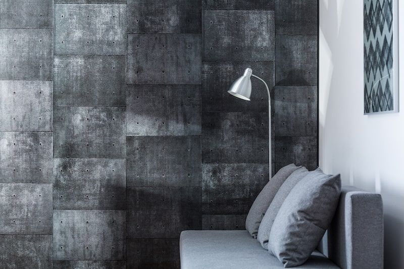 grey coloured sofa and wall