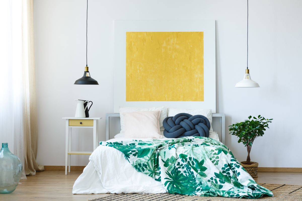 a mostly white wall with an yellow square