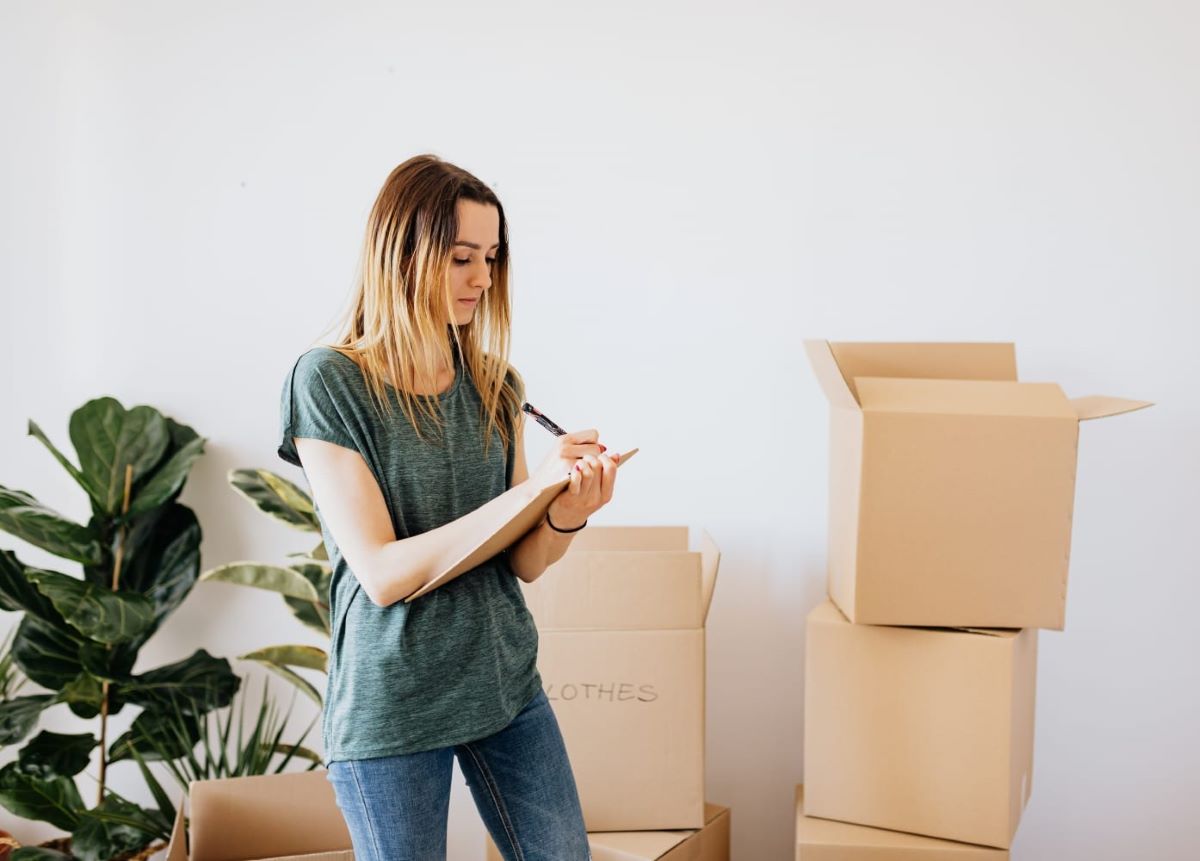 Woman making a list of moving items