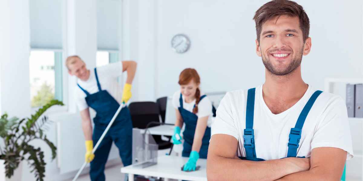 professional cleaners happily cleaning a room