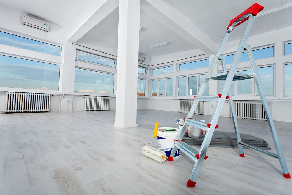 painting in an office with a step-ladder