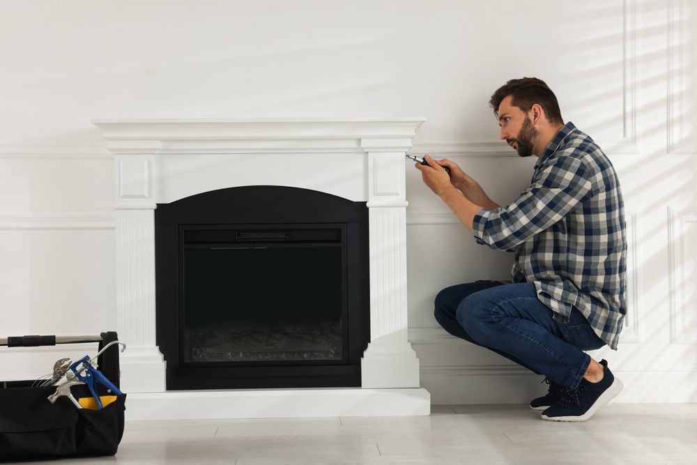A man fixing a fireplace