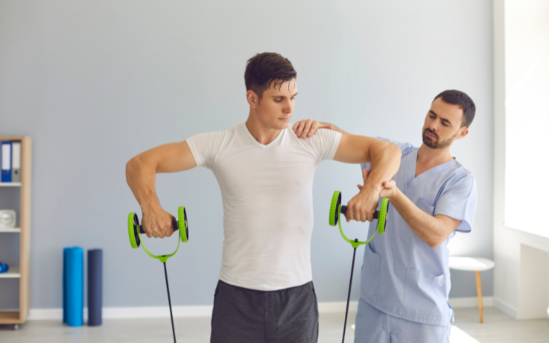 A physiotherapist helping a patient exercise