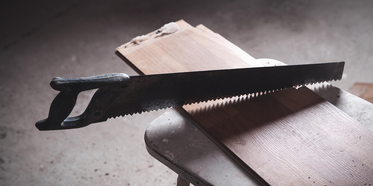 Handsaw on a plank of wood