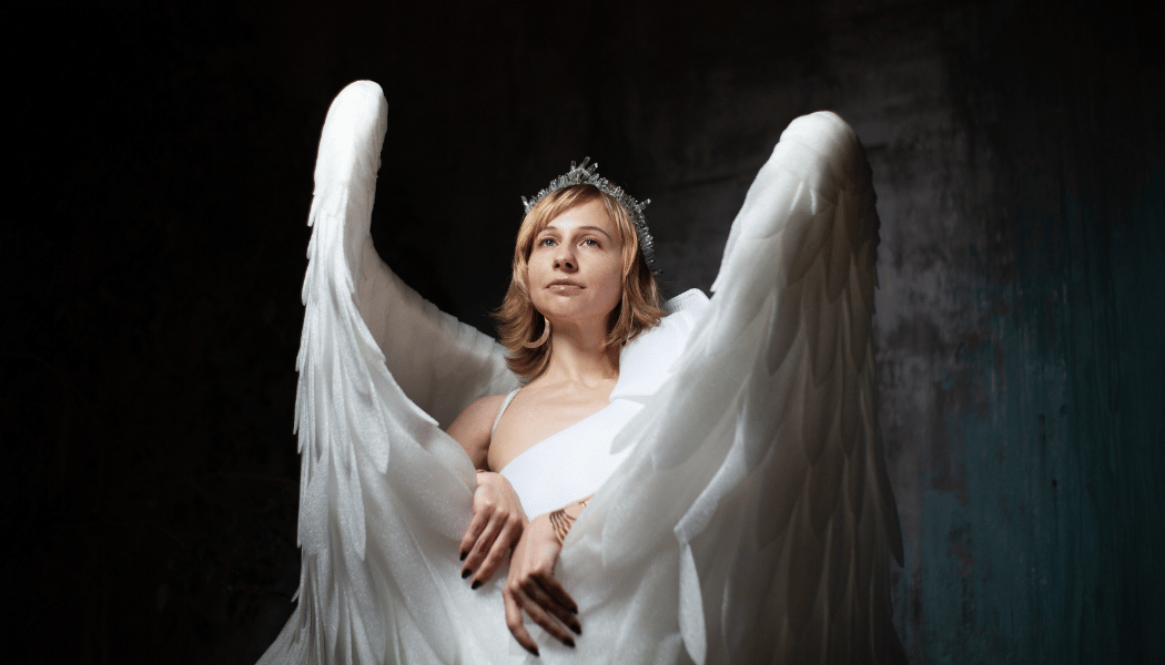 Woman dressed as an angel, artificial lighting