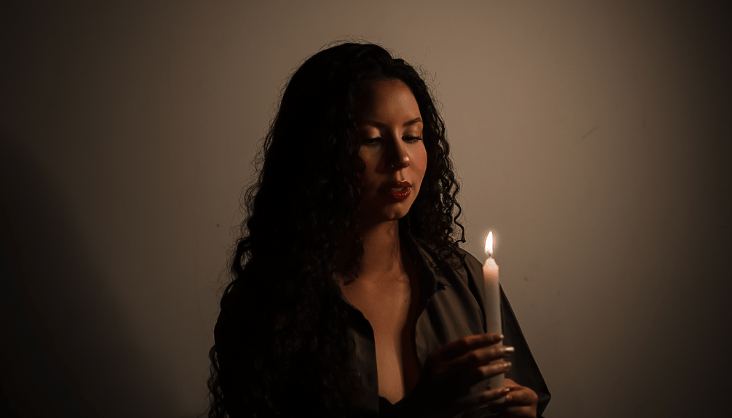 Woman's face lit by candle flame