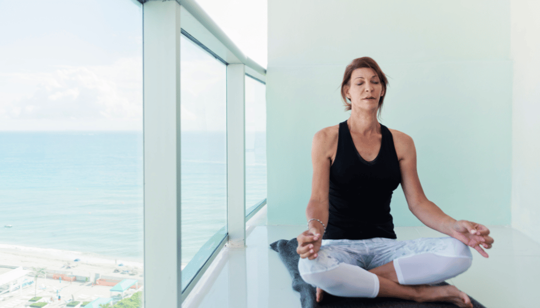 Woman doing yoga in a balcony