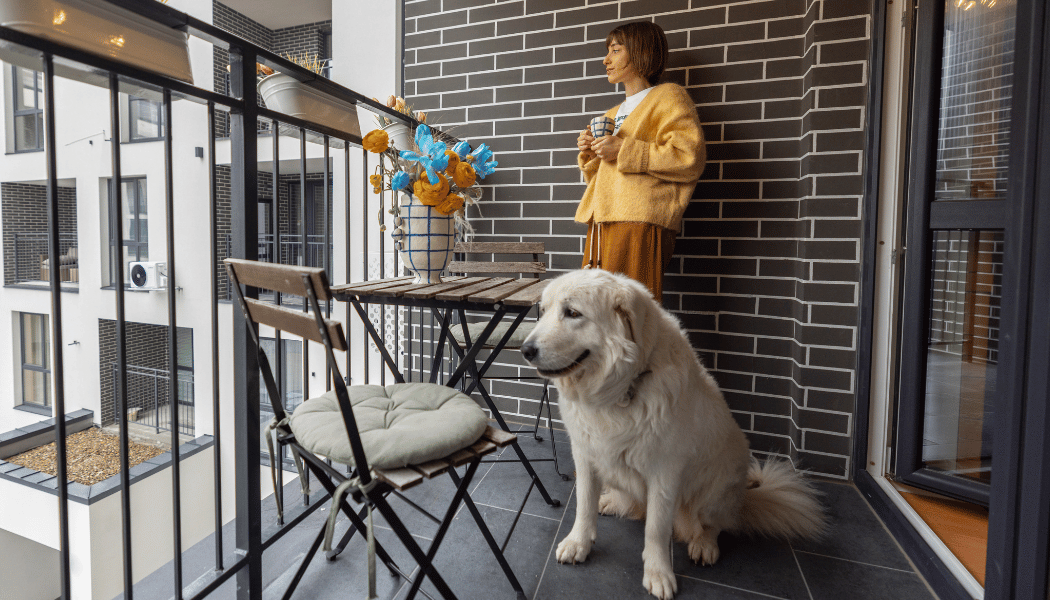 Woman enjoying her time in the balcony with her pet dog