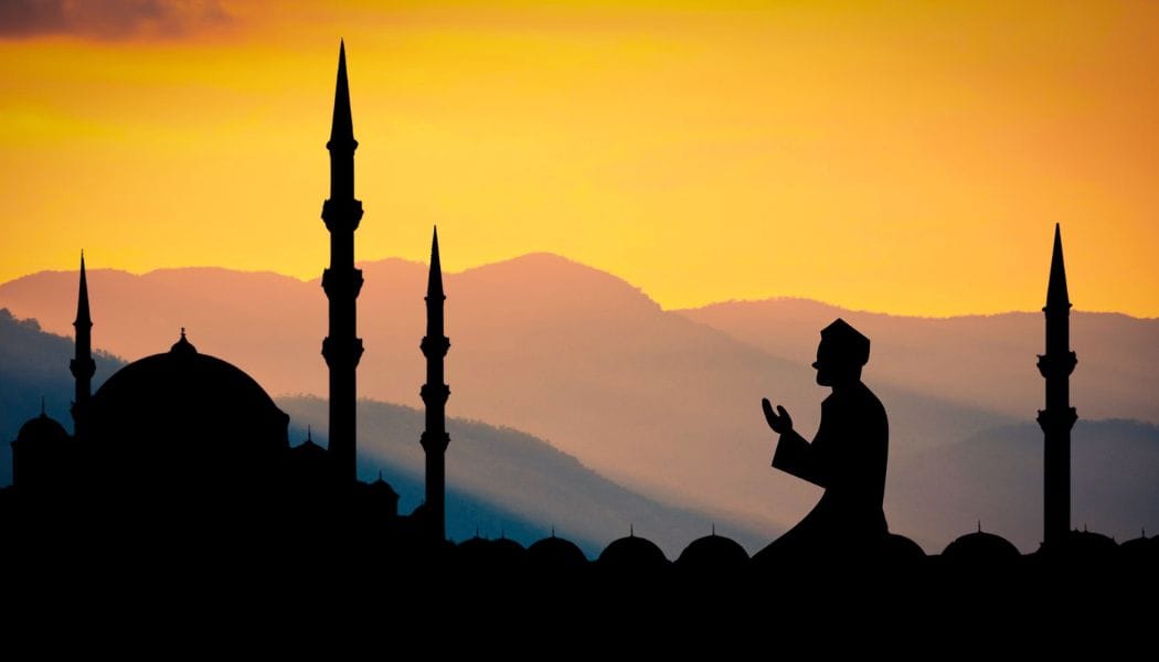 man praying during sunset