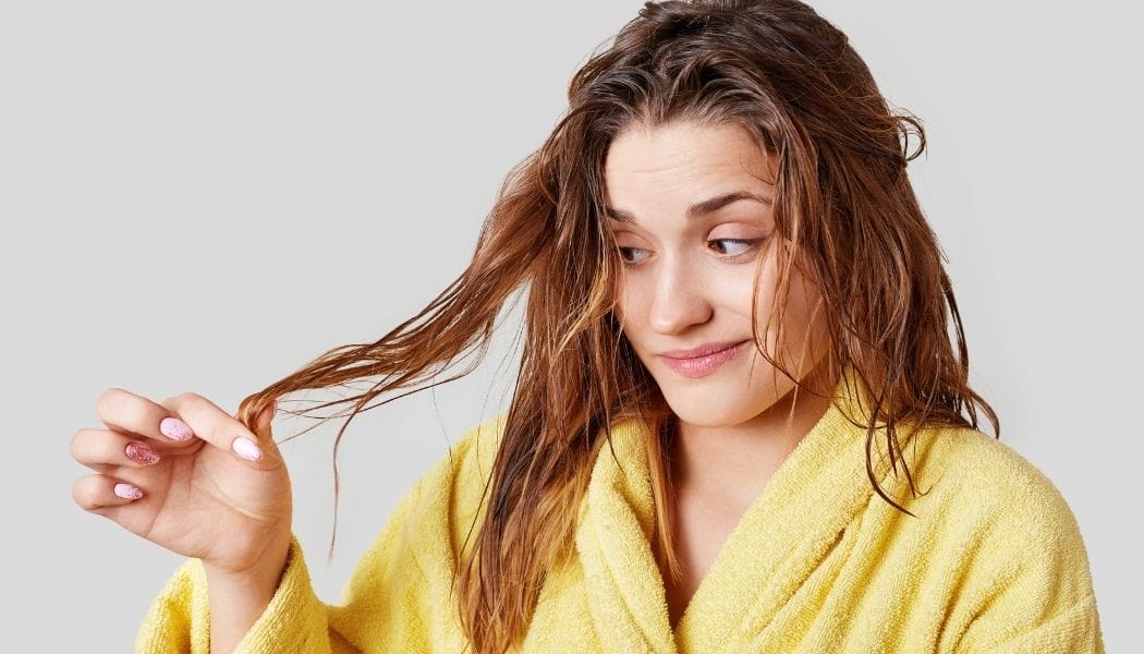 Woman dissatisfied with frizzy hair
