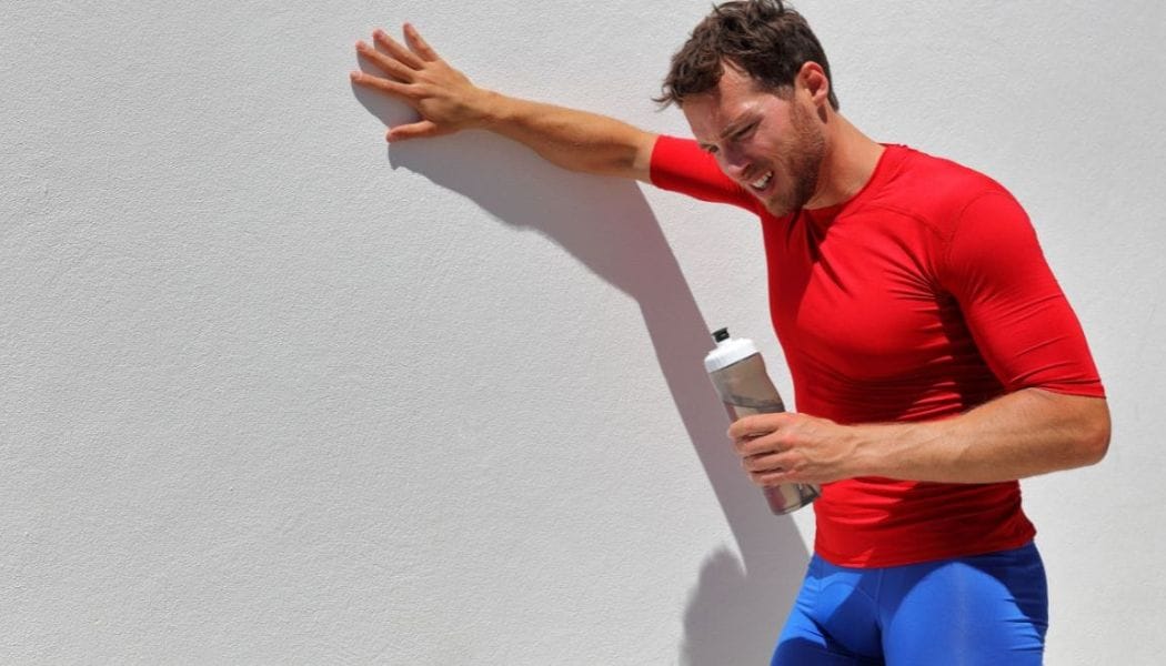 a dehydrated guy holding a bottle of water