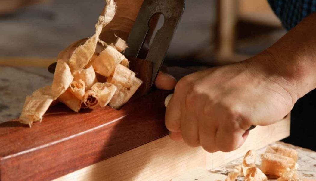 a person using a block plane