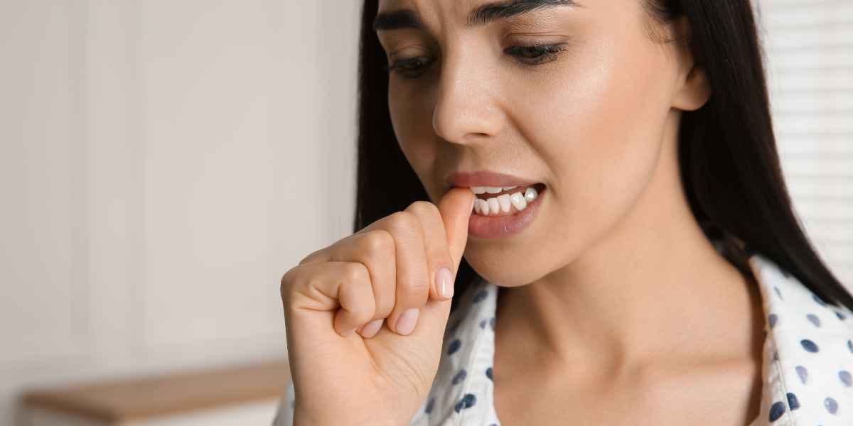 Woman biting her nails