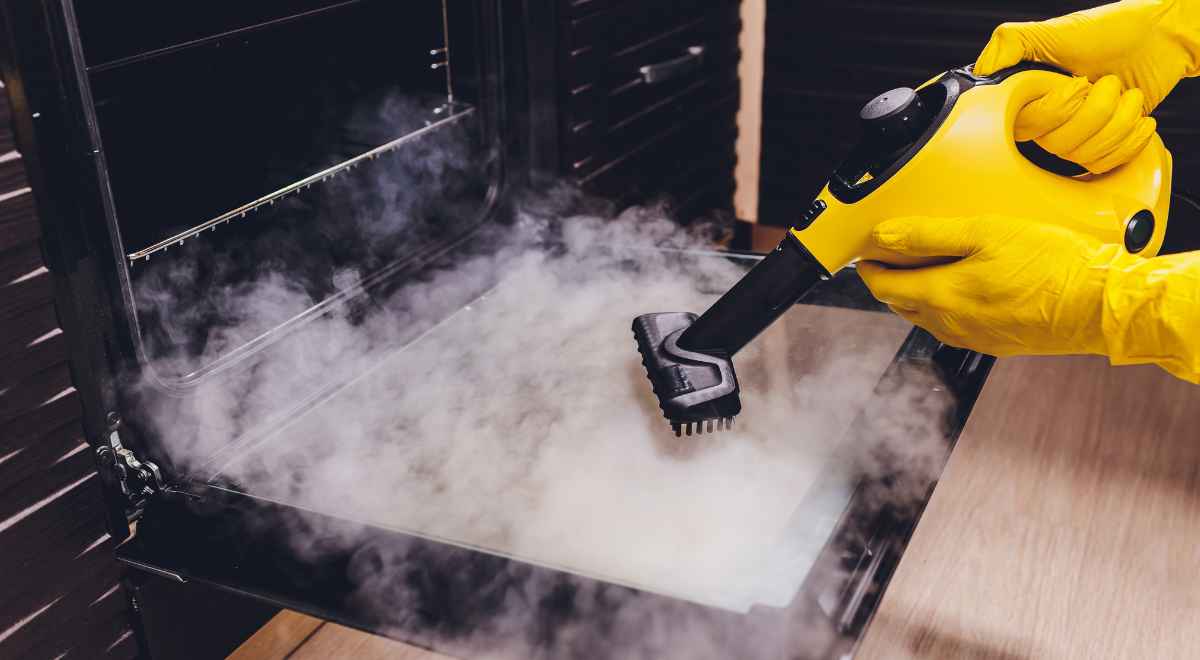 Cleaning professional steam cleaning an oven