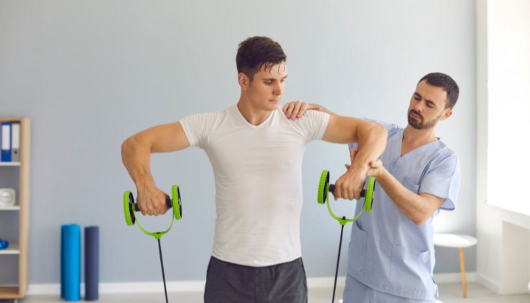 A physiotherapist helping a patient exercise