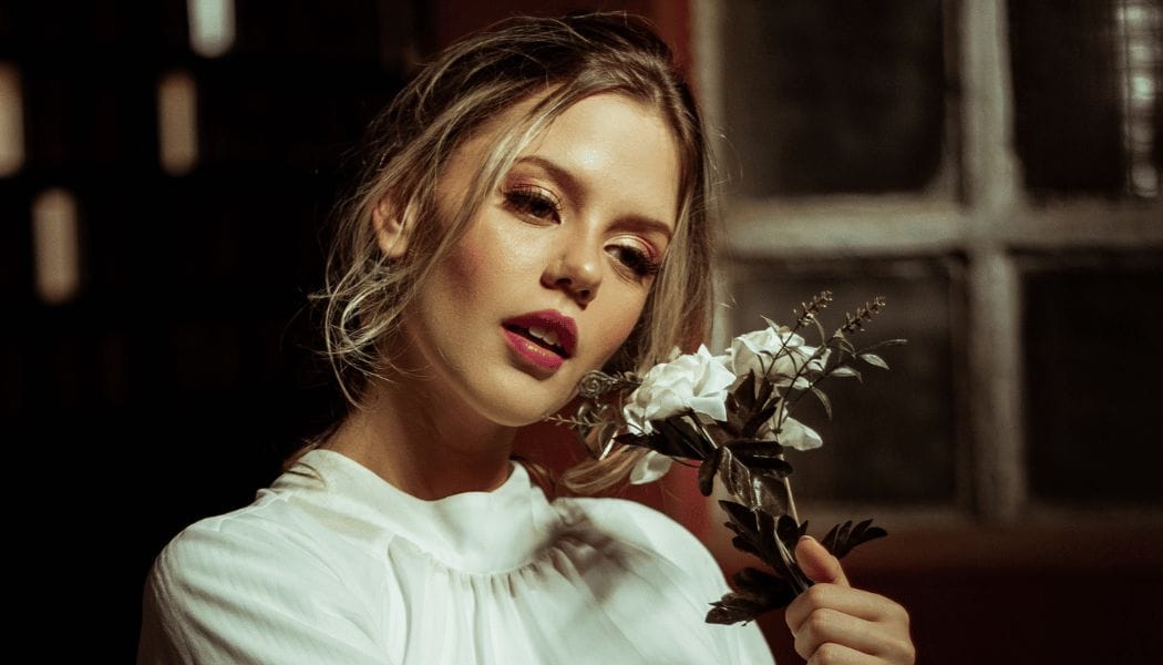 Beautiful woman holding white roses, Butterfly lighting