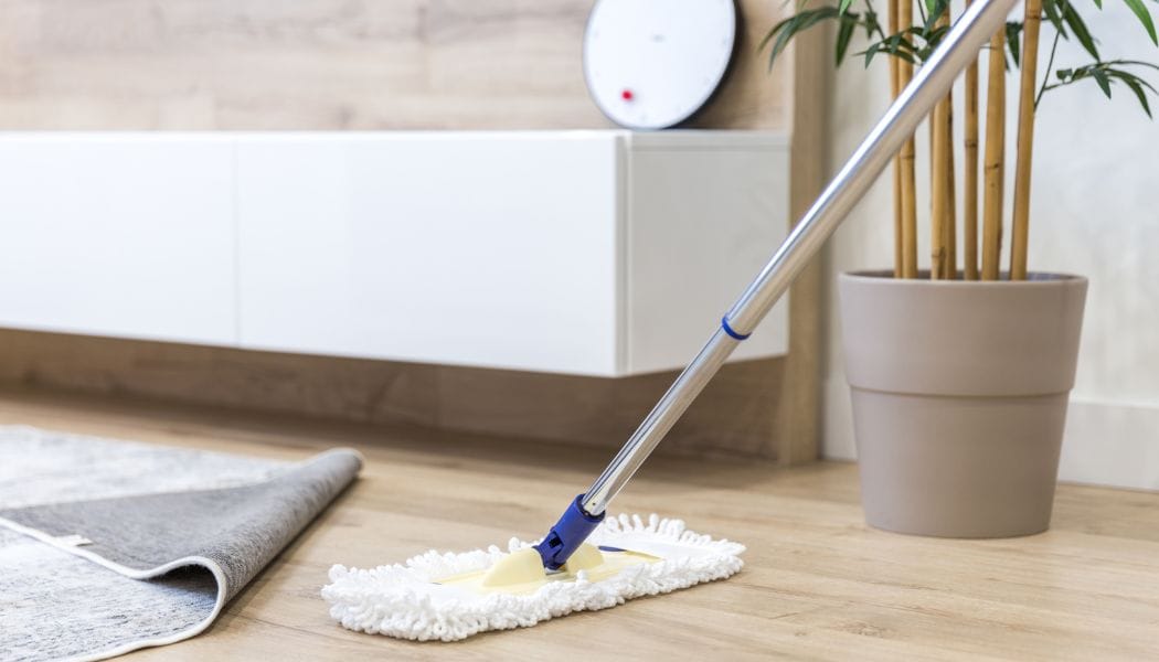 Cleaning Wooden Floor with White Mop