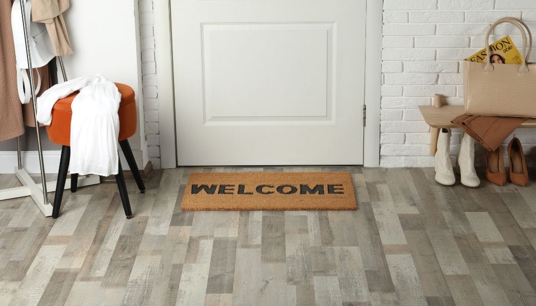 Welcome Doormat on Wooden Floor in Hall