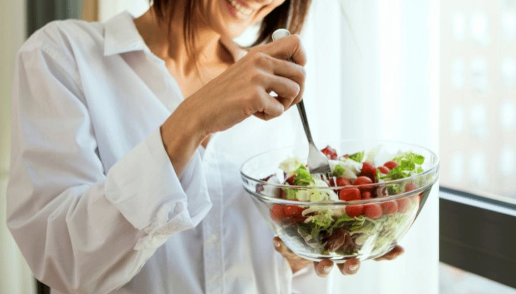 woman eating food with healthy fats