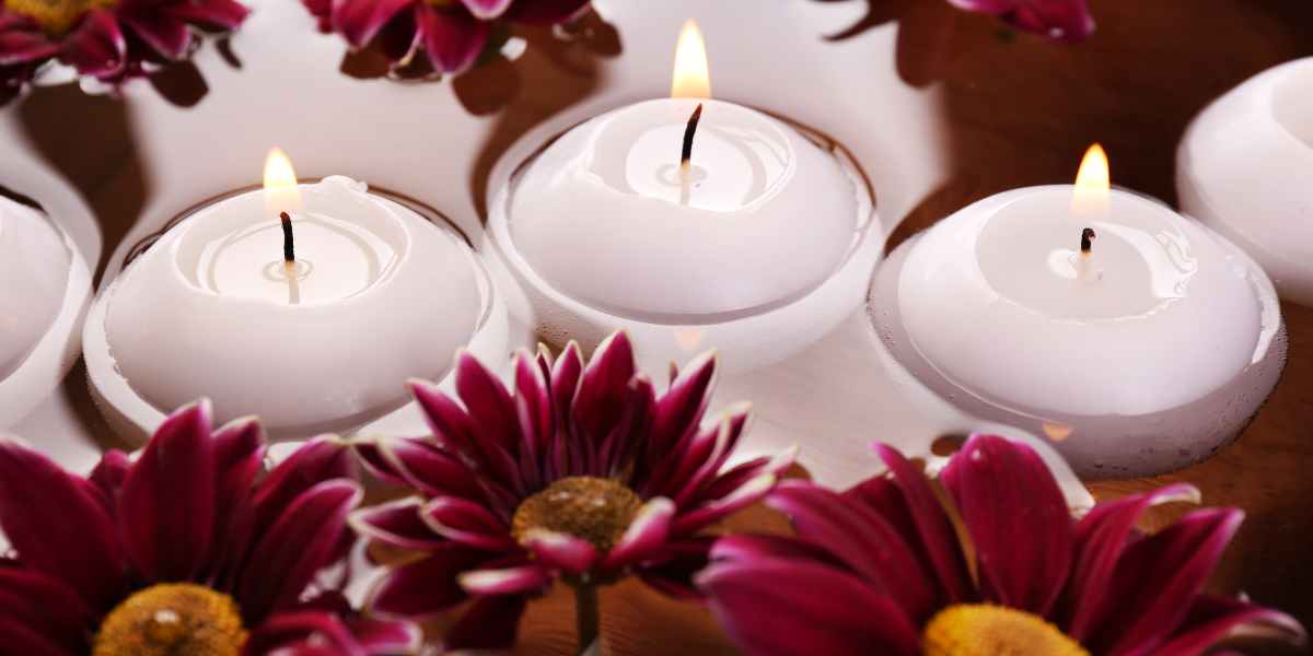 Colourful warm floating candles and flowers