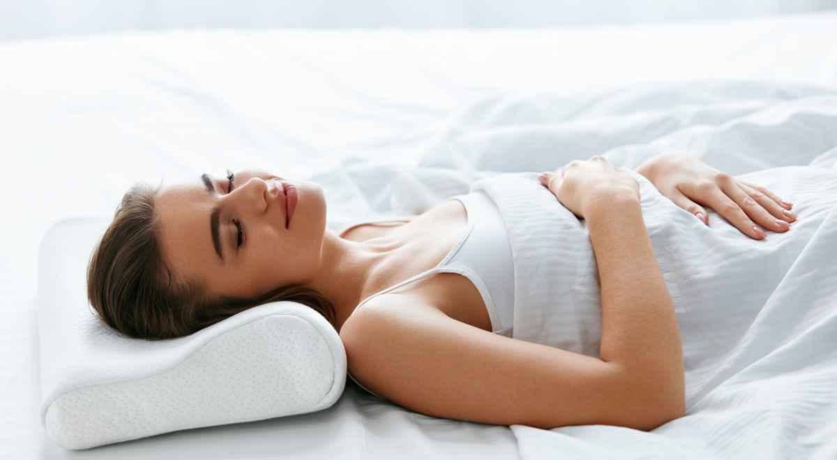 a woman sleeping on a Cervical Pillow