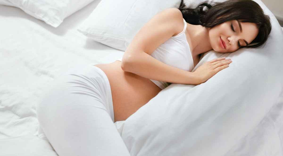 woman sleeping with a body pillow