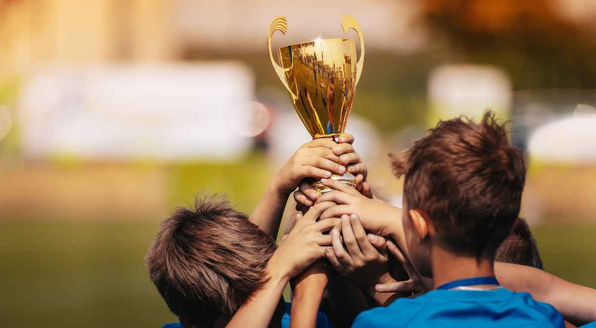 Kids holding their winning trophy