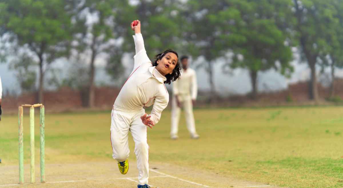 a child throwing cricket ball