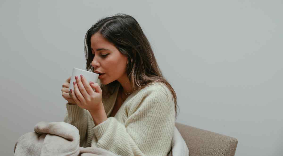 A woman sipping lemongrass tea