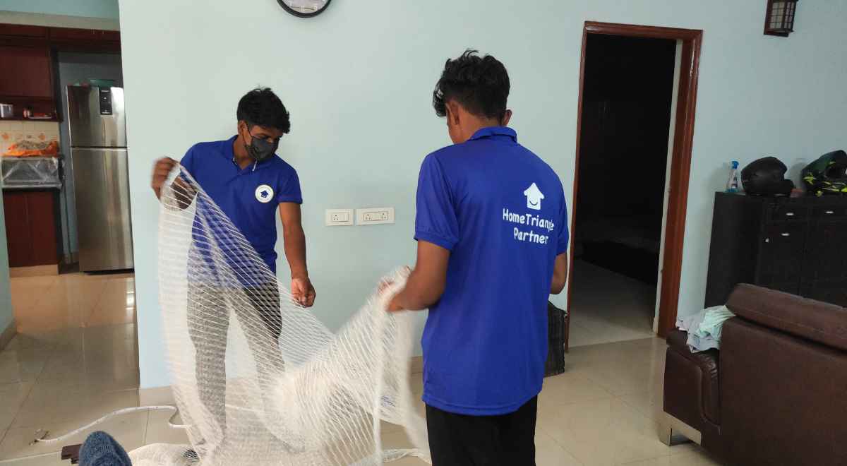 Hometraingle vendors working on the bird net installation