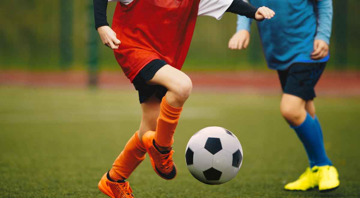 two kids playing football