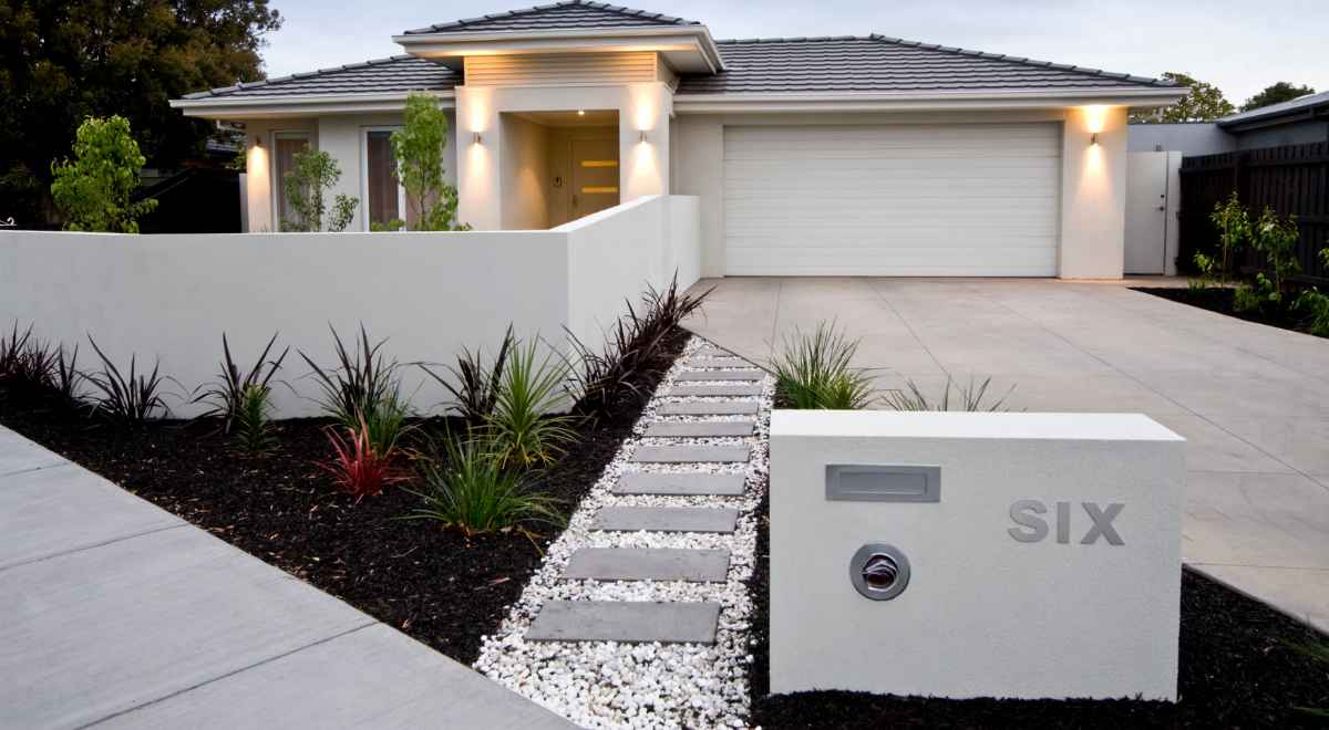 Contemporary home exterior with accents of different materials like wood, stone and synthetic cladding