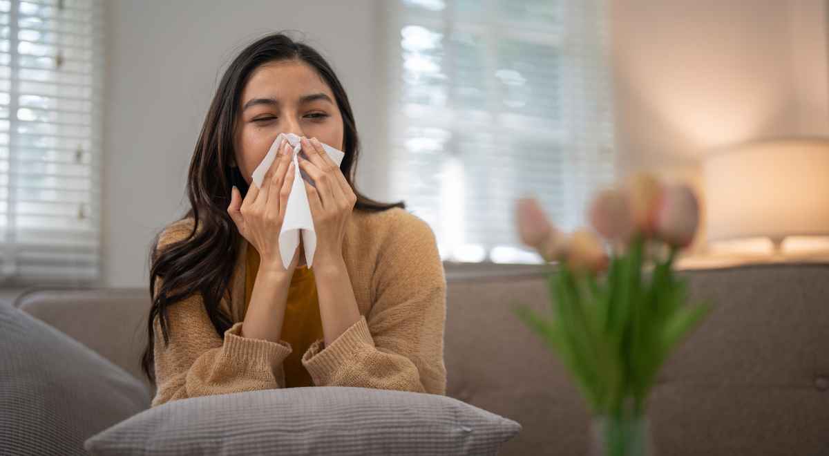 a girl sneezing due to allergy