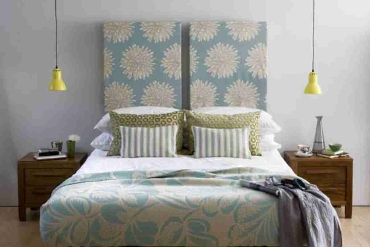 Bright yellow pendant lights flank the bed