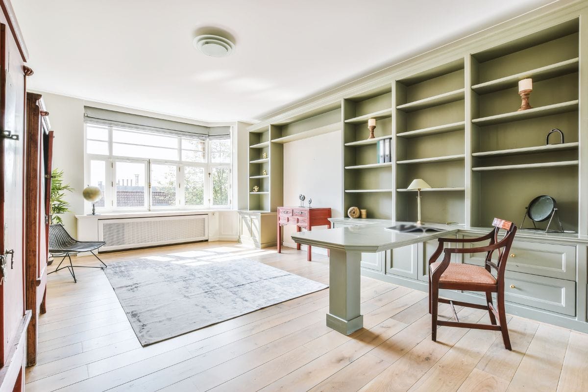A Round Mirror In A Bookcase