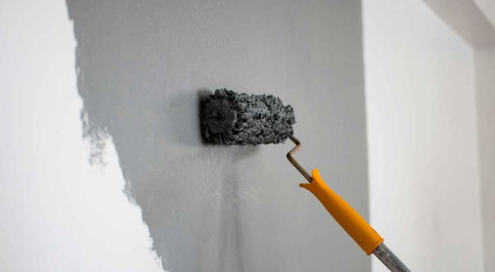 painting a white wall grey with a roller brush