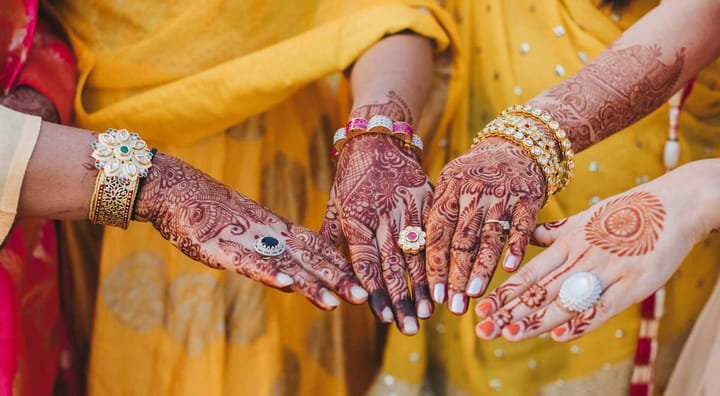 Women Hands Showcasing Mehndi Designs