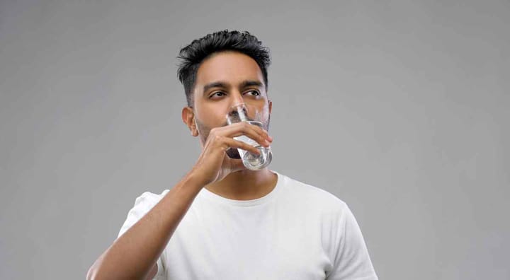 A boy drinking water while in water fasting