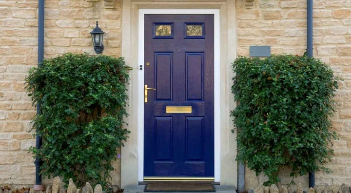 a front door painted blue and decorated well