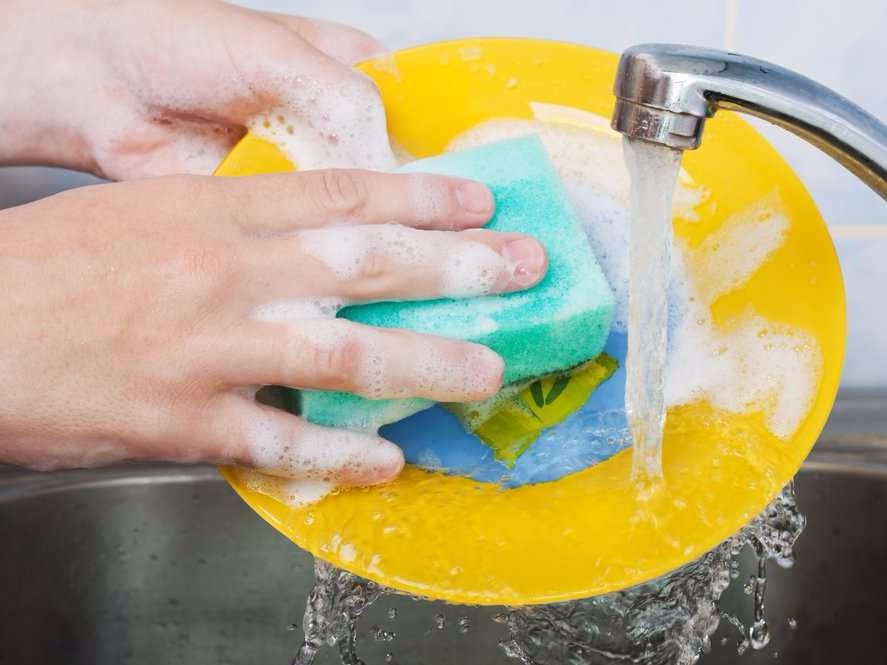 a plate being scrubbed