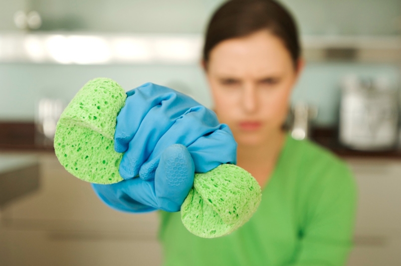 a woman sweezing a cleaning scrub