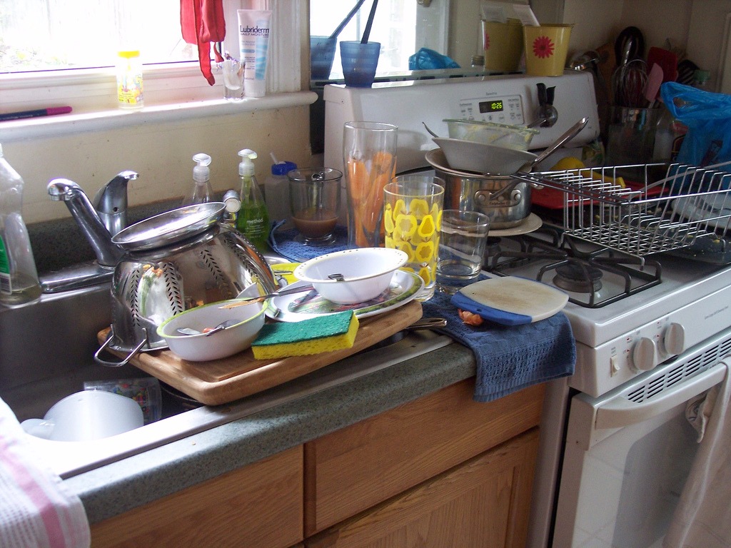 dirty dishes piles in the sink