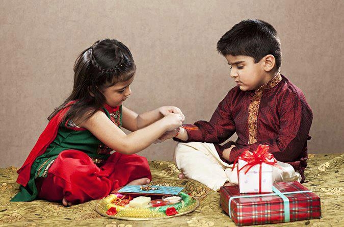 sister tying rakshabandhan thread to her brother