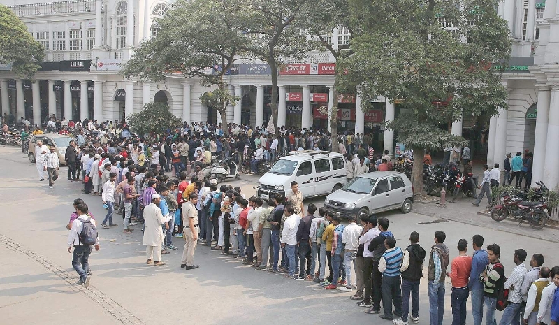 people standing in a queue outside banks