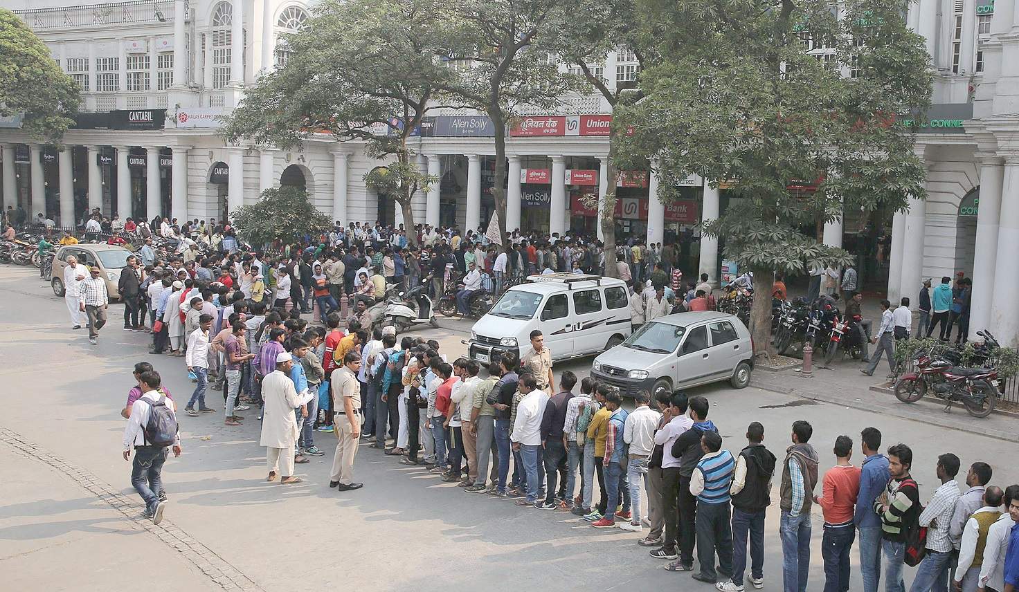 people standing in a queue outside banks