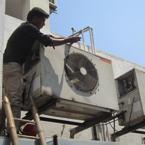 Technician repairing an AC