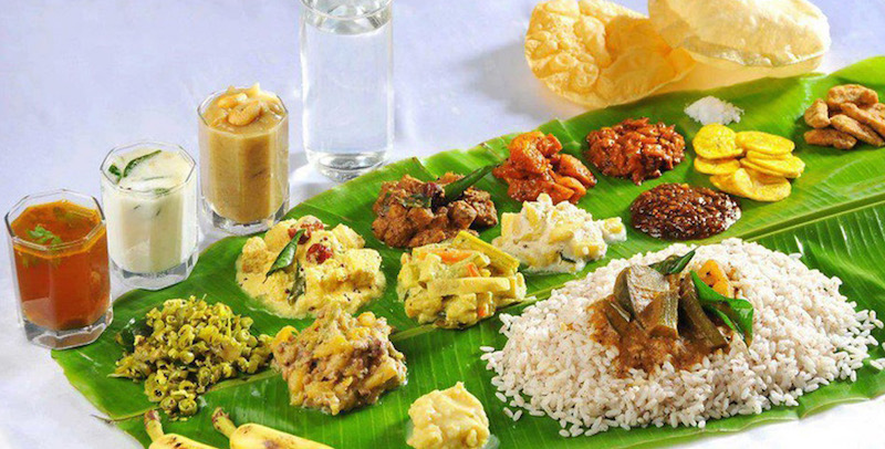 Onam food laid out on a banana leaf