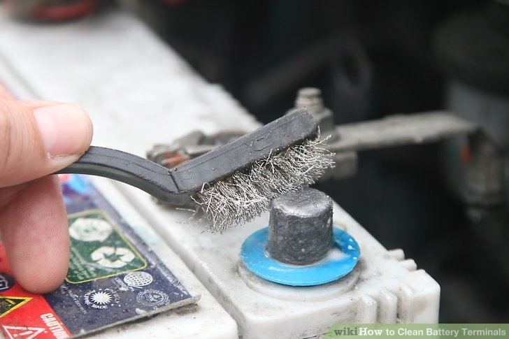 terminal of an inverter being cleaned with a brush